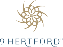 The 9 Hertford Street logo which has a flower pattern made out of a circle of gold 9s, with 9 Hertford St in text below.