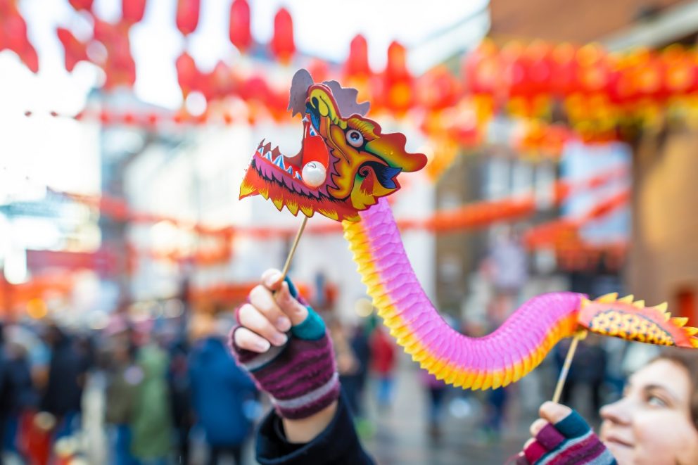 Chinese New Year dragon decoration being held up in Chinatown, London.